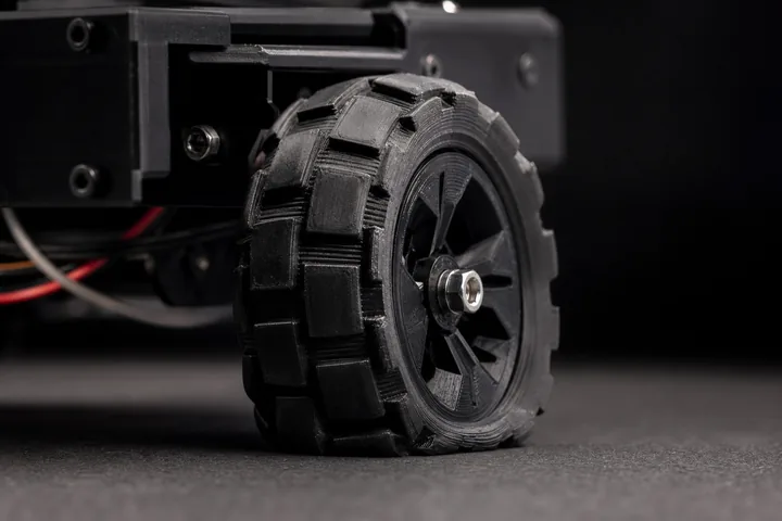 Llanta con tacos impresa en TPU flexible montada en el chasis de un robot